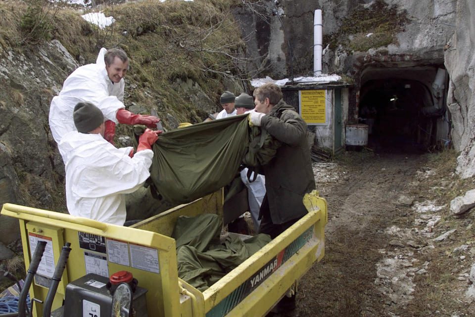 FILE - Experts load body bags next to a service tunnel that connects to the Kitzsteinhorn mountain tunnel in Kaprun, Austria on Nov. 14, 2000, where they have started recovering the remains of the victims that died in the cable car disaster on Nov. 11, 2000. Rail travel in Europe is a common and relatively affordable and convenient way for many Europeans to travel. It also has a good safety record overall, growing safer in past years. Yet the tragedy in Greece on Wednesday is a reminder of how deadly crashes can be when they happen. (AP Photo/Franz Neumayr, Pool, File)
