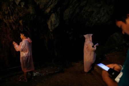 Journalists use their phone as they report in Tham Luang caves during a search for 12 members of an under-16 soccer team and their coach, in the northern province of Chiang Rai, Thailand, June 27, 2018. REUTERS/Soe Zeya Tun