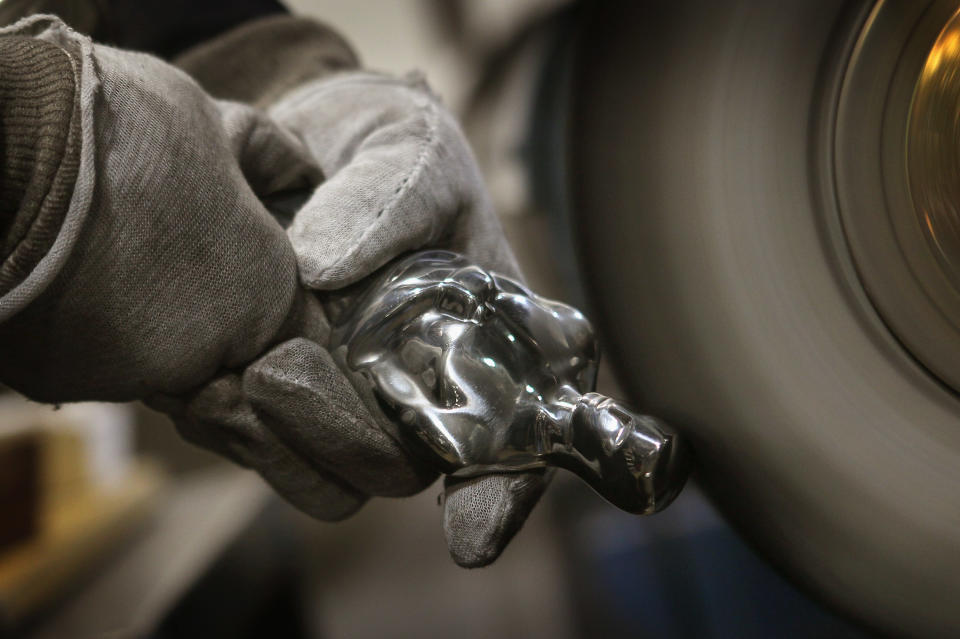 CHICAGO, IL - FEBRUARY 09: A worker polishes an Oscar statuette at R.S. Owens & Company February 9, 2012 in Chicago, Illinois. R.S. Owens manufactures the Oscar statuettes which are presented at the annual Academy Awards by the Academy of Motion Picture Arts and Sciences. After the theft of the statuettes prior to the 2000 Academy Awards the company began casting the statuettes one year in advance of the show. (Photo by Scott Olson/Getty Images)