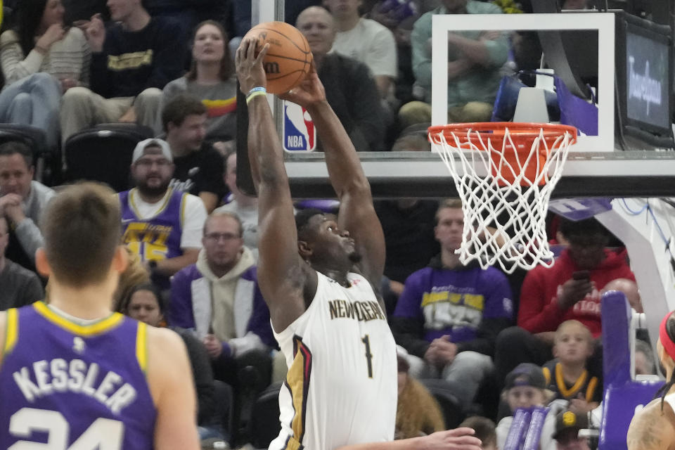 New Orleans Pelicans forward Zion Williamson (1) dunks against the Utah Jazz during the first half of an NBA basketball game Monday, Nov. 27, 2023, in Salt Lake City. (AP Photo/Rick Bowmer)