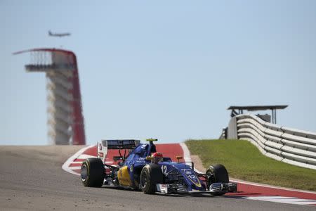 An aircraft flies overhead as Sauber's Felipe Nasr of Brazil participates in the second practice session. REUTERS/Adrees Latif