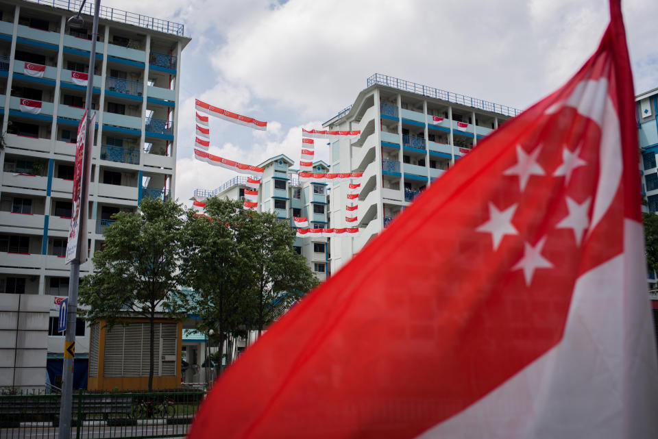 SINGAPORE - 2020/08/09: A number 55 that was made up of Singapore flags seen hanging in between two buildings at a local estate in Singapore. Singapore celebrates its 55th National Day on the 9th of August 2020 amid the Covid-19 pandemic. (Photo by Maverick Asio/SOPA Images/LightRocket via Getty Images)