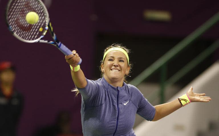 Victoria Azarenka of Belarus returns the ball to Venus Williams of the USA during their women's singles semi-final tennis match during the Qatar Open tennis tournament on February 27, 2015 in Doha