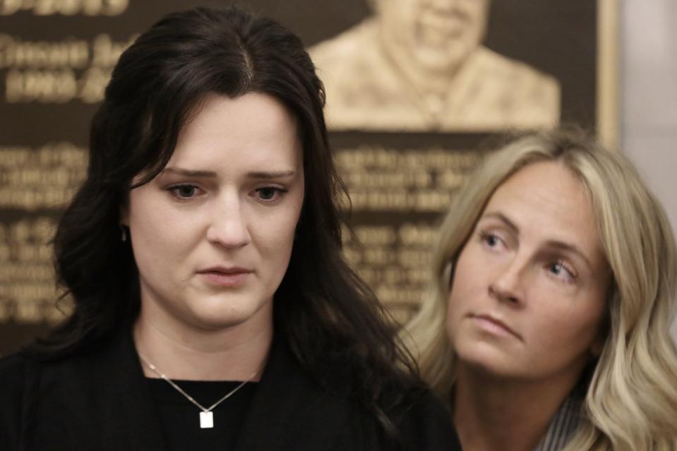 Kirsten Bridegan, the widow of Jared Bridegan, is comforted by Jared's sister-in-law Karlee as she reads a statement after the arraignment for accused killer Henry Tenon on Feb. 13, 2023, in the Duval County Courthouse.