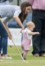 <p>The young royal toddles along with the help of his mom at Cirencester Park Polo Club.</p>