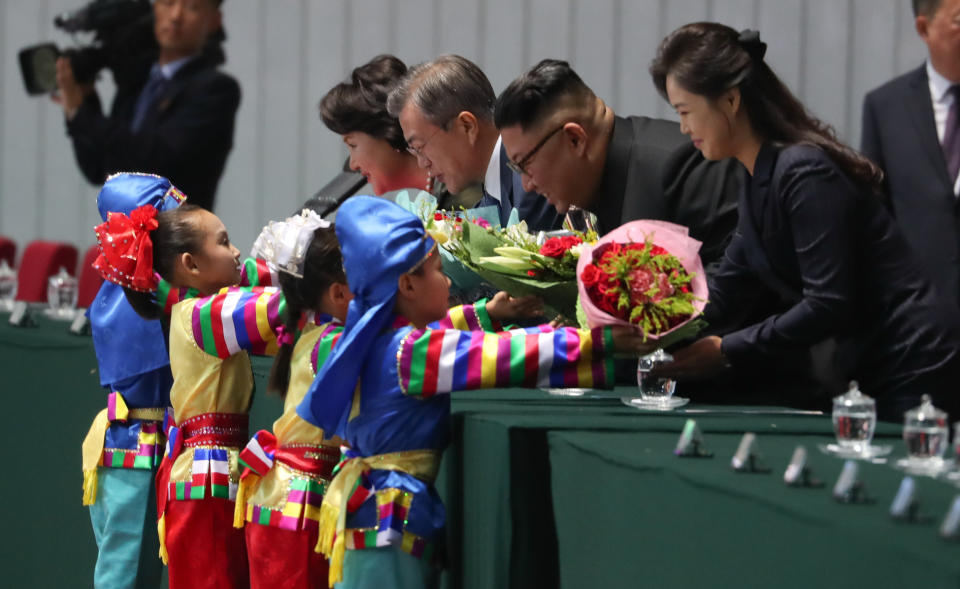 In this Wednesday, Sept. 19, 2018, file photo, receiving flowers from children, from left, South Korean President Moon Jae-in, his wife Kim Jung-sook, North Korean leader Kim Jong Un, and his wife Ri Sol Ju, before the mass games performance of "The Glorious Country" at May Day Stadium in Pyongyang, North Korea. (Pyongyang Press Corps Pool via AP, Filer)