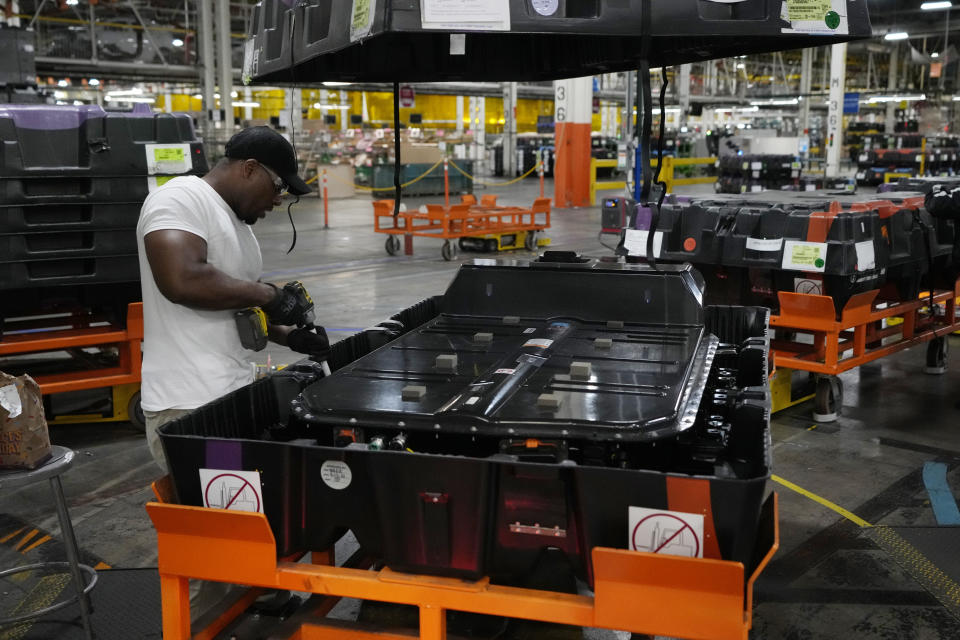 File - An assembly line worker uncrates an LG battery at the General Motors Orion Assembly, Thursday, June 15, 2023, in Lake Orion, Mich. On Friday, the U.S. government issues the October jobs report. (AP Photo/Carlos Osorio, File)