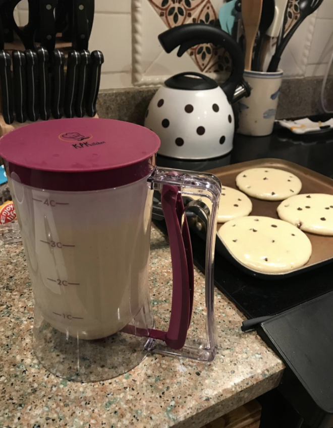 The batter dispenser next to perfectly round pancakes