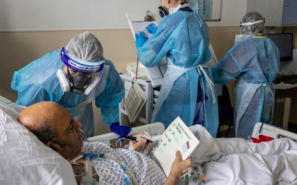 Mr Akram had a temporary tracheostomy to assist his airway and needs to write messages on a white board to communicate - Heathcliff O'Malley