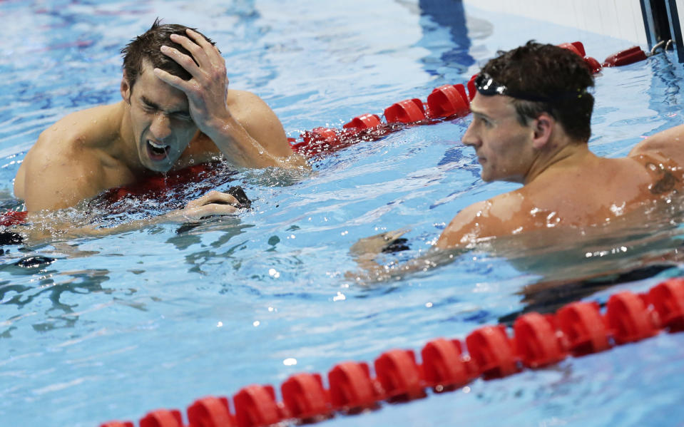 Michael Phelps (L) and Ryan Lochte of the U.S. react after their men's 200m individual medley semi-final during the London 2012 Olympic Games at the Aquatics Centre August 1, 2012. REUTERS/Tim Wimborne (BRITAIN - Tags: SPORT SWIMMING OLYMPICS TPX IMAGES OF THE DAY) 