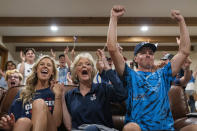 Cousin Haley Crouser, left, grandmother Marie Crouser, center, and brother Matt Crouser, right, watch with other friends and family as Ryan Crouser wins the gold medal at the shot put finals at the Tokyo Olympics, Wednesday, Aug. 4, 2021, in Redmond, Ore. (AP Photo/Nathan Howard)