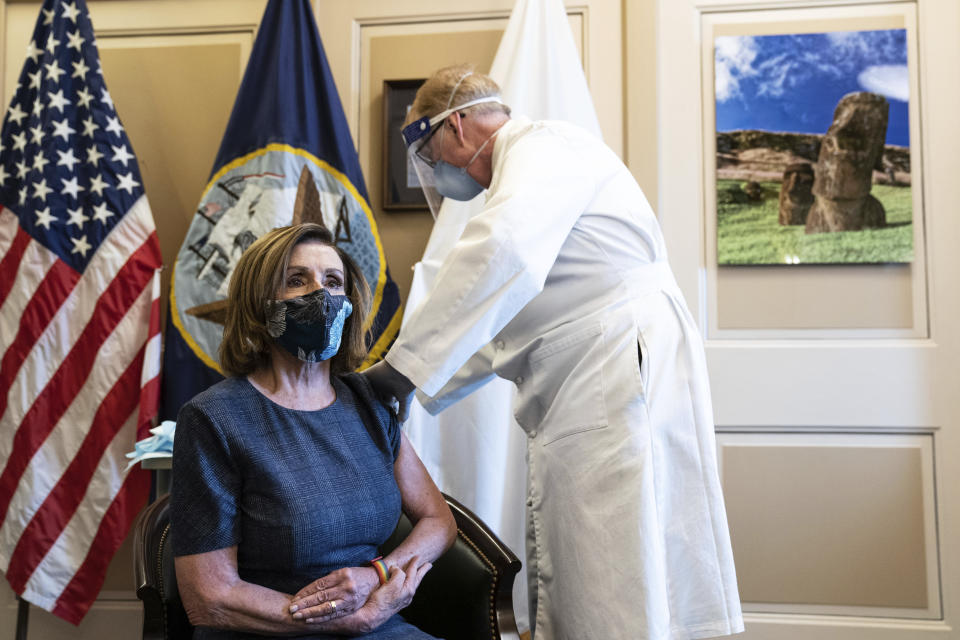 Speaker of the House Nancy Pelosi, D-Calif., receives a Pfizer-BioNTech COVID-19 vaccine shot by Dr. Brian Monahan, attending physician Congress of the United States in Washington, Friday, Dec. 18, 2020. (Anna Moneymaker/The New York Times via AP, Pool)