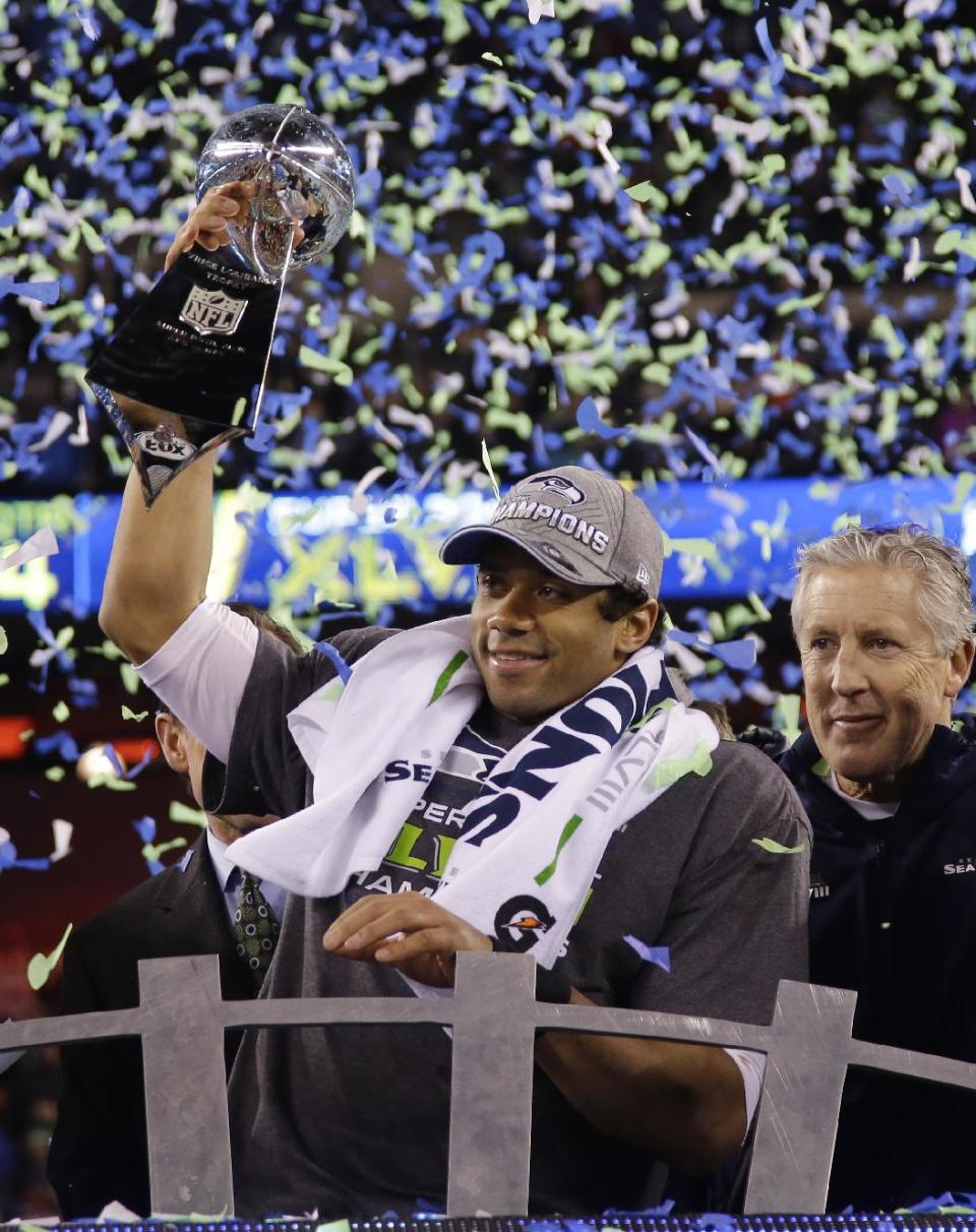 Seattle Seahawks' Russell Wilson holds the Vince Lombardi Trophy after the NFL Super Bowl XLVIII football game against the Denver Broncos Sunday, Feb. 2, 2014, in East Rutherford, N.J. The Seahawks won 43-8. (AP Photo/Matt Slocum)