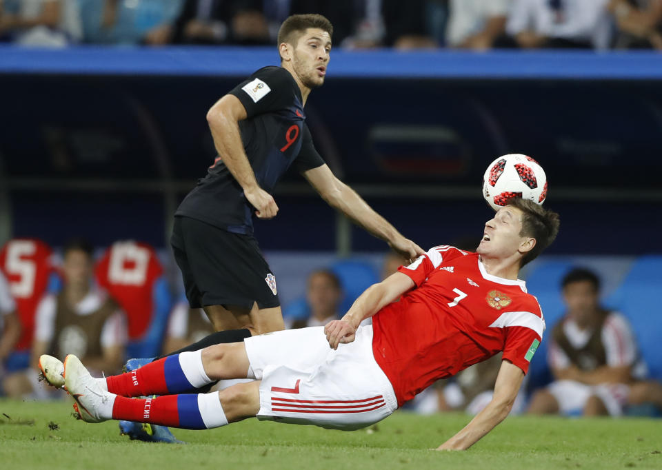 Croatia’s Andrej Kramaric, left, vies for the ball with Russia’s Daler Kuziaev during the quarterfinal match between Russia and Croatia at the 2018 soccer World Cup in the Fisht Stadium, in Sochi, Russia, Saturday, July 7, 2018. (AP Photo/Darko Bandic)