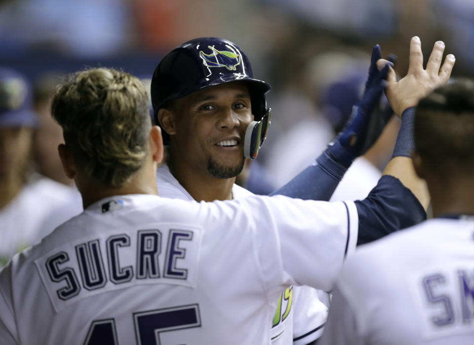 Carlos Gómez had every reason to smile after robbing a home run Tuesday. (AP Photo)