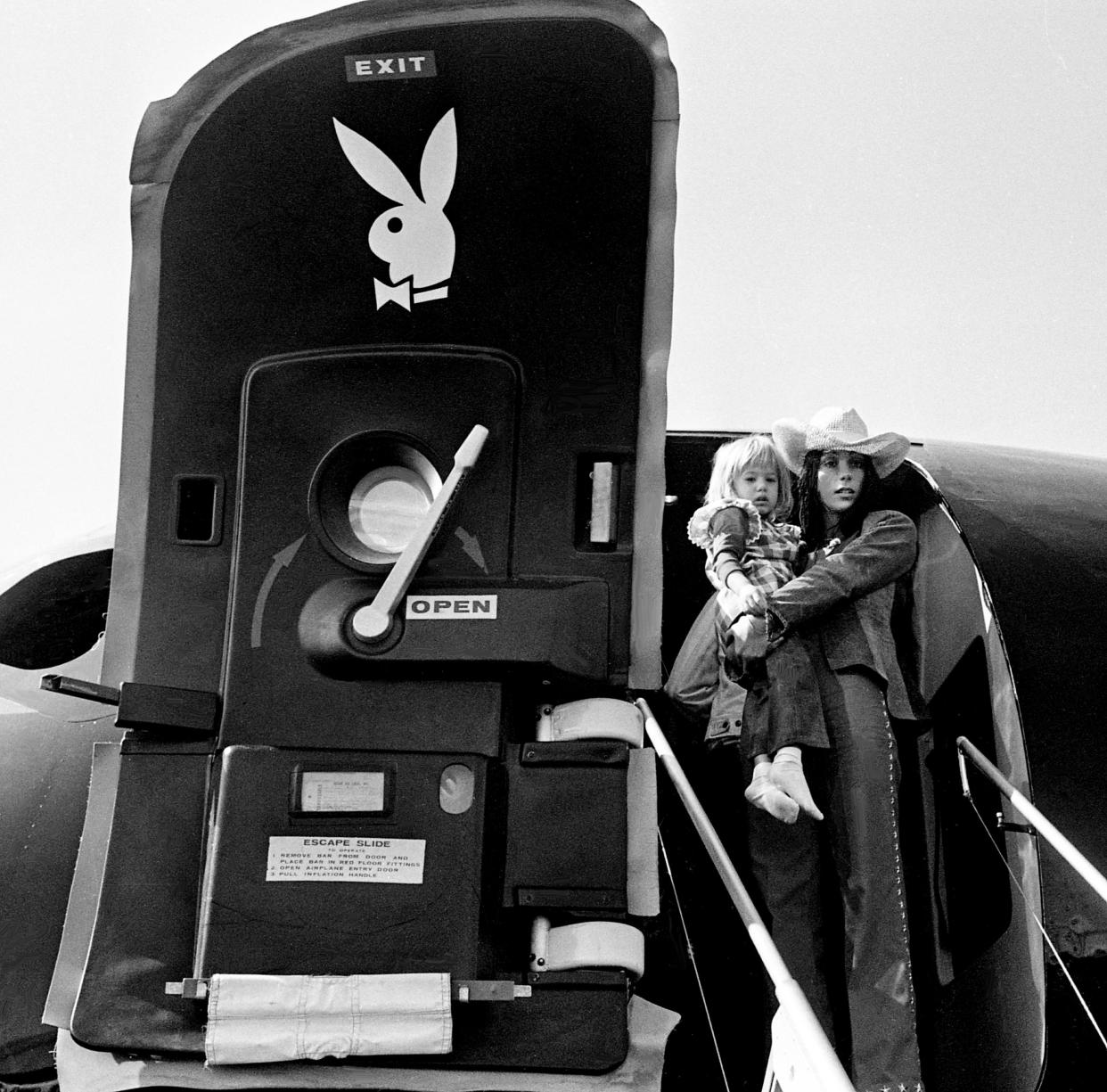 Cher, with 3-year-old daughter, Chastity, exits Hugh Hefner's luxurious Playboy jetliner, appropriately dubbed "The Big Bunny," at Berry Field April 14, 1973. Sonny and Cher are in town for a "sold out" concert at the Municipal Auditorium.
