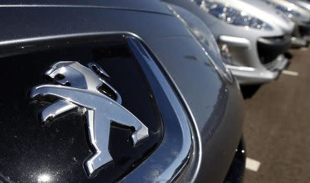 The Peugeot logo is seen on a car at a dealership of French car maker PSA Peugeot-Citroen in Selestat, eastern France, September 7, 2012. REUTERS/Vincent Kessler