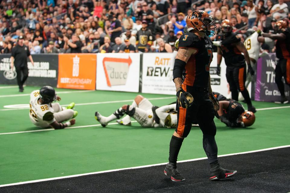Rattlers running back Shannon Brooks (3), right, skips past a series of challenges to score a touchdown during the second half against the San Diego Strike Force at the Footprint Center on Friday, April 15, 2022, in Phoenix. The Rattlers won the game 66-33.