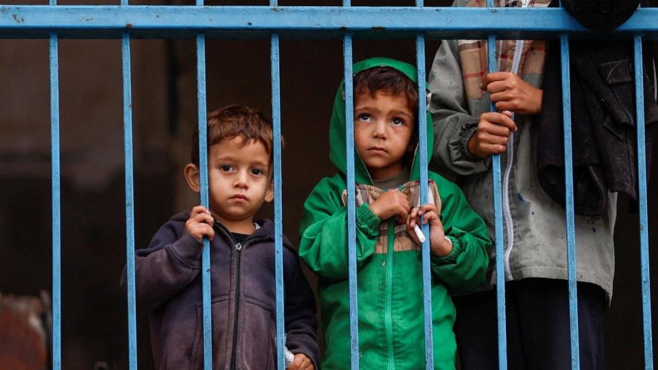 PHOTO: Displaced Palestinian children stand at a school as they wait to flee Rafah after Israeli forces launched a ground and air operation in the eastern part of the southern Gaza City on May 13, 2024.  (Mohammed Salem/Reuters)