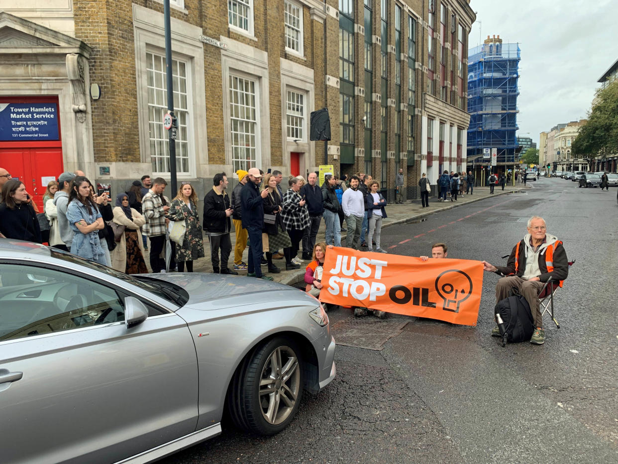 Just Stop Oil activists blocking the road on Commercial Street in east London. Issue date: Sunday October 30, 2022.