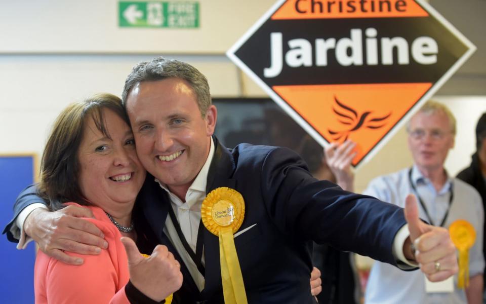 Liberal Democrat politician Christine Jardine (L) celebrates with Alex Cole - Hamilton after she wins her seat of Edinburgh West at the Meadowbank Sports Centre counting centre in Edinburgh - Credit: AFP