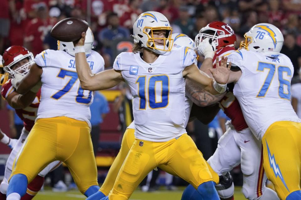 Chargers quarterback Justin Herbert (10) passes under pressure against the Kansas City Chiefs.