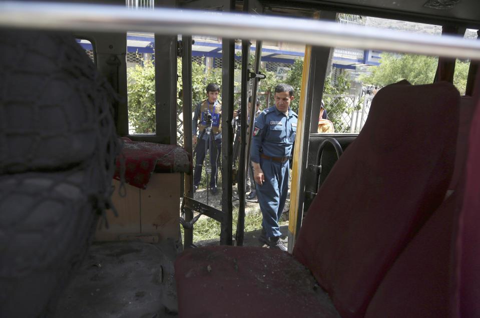 An Afghan security police work at the site of an explosion in Kabul, Afghanistan, Sunday, June 2, 2019. Afghan officials say there have been three explosions in the capital, Kabul, including a sticky bomb attached to a bus carrying university students. (AP Photo/Rahmat Gul)