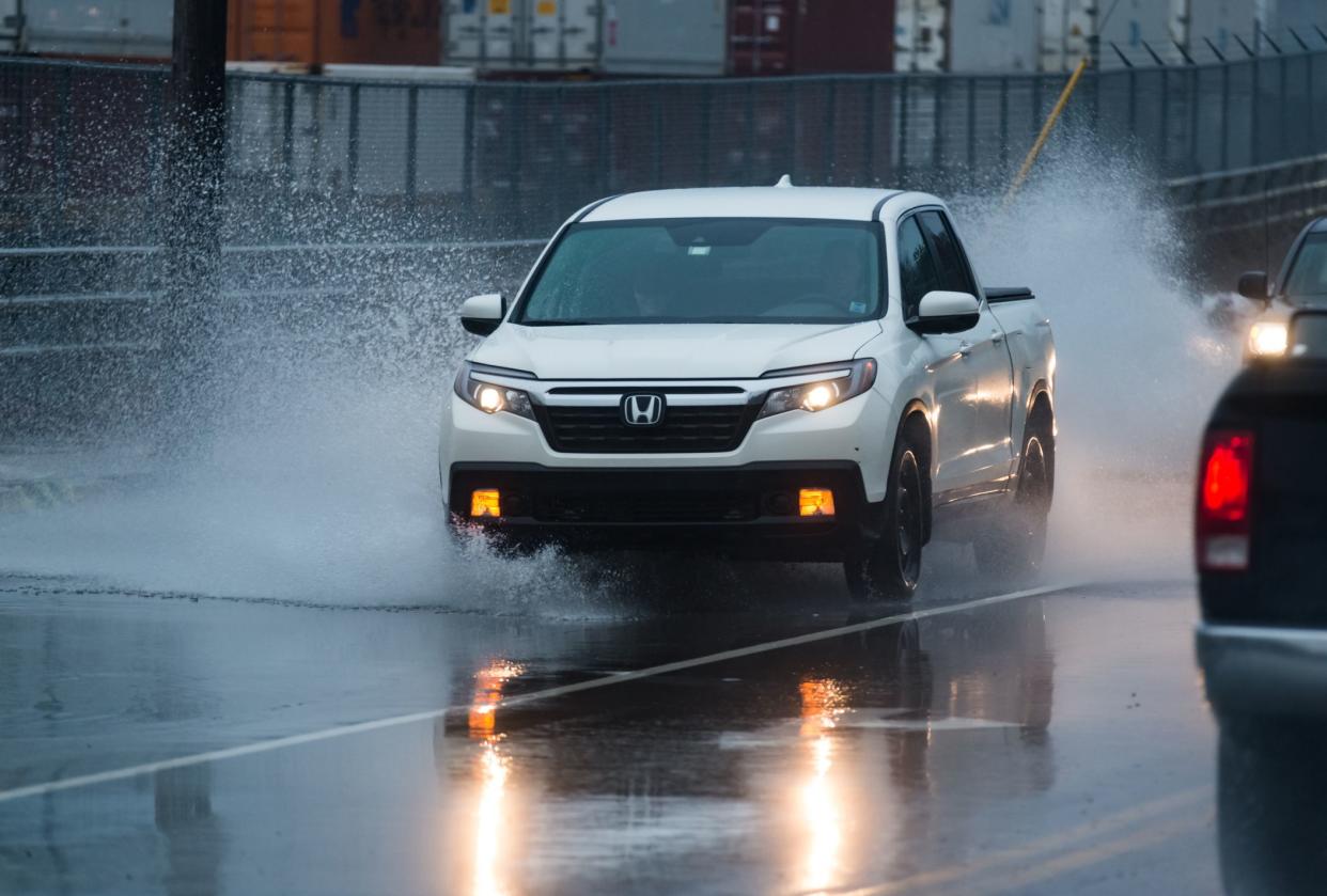 Halifax, Canada - January 9, 2019 - The driver of a Honda Ridgeline navigates a flooded portion of the Bedford Highway after heavy rains.
