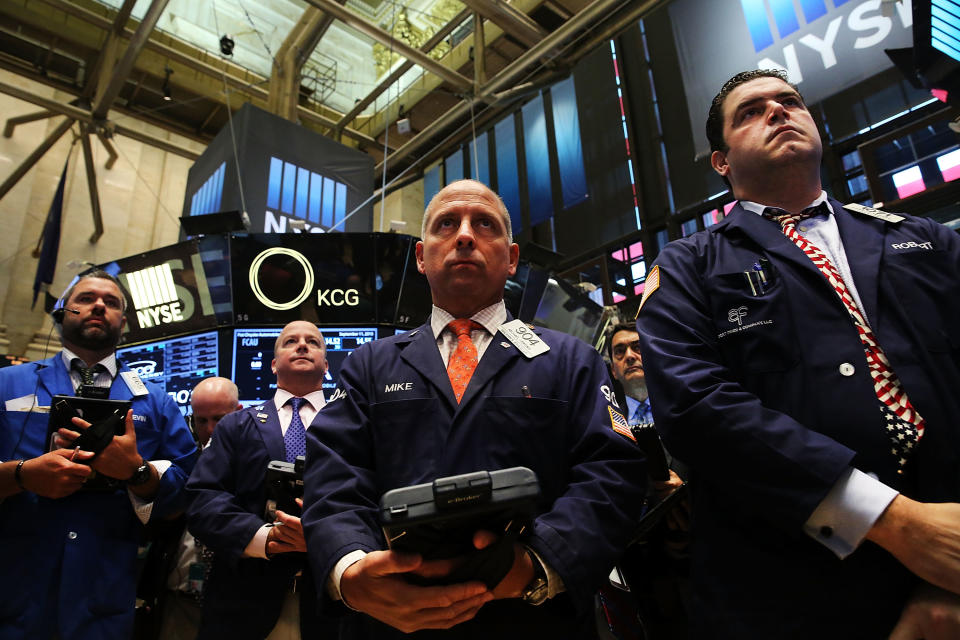 NEW YORK, NY - SEPTEMBER 11:  Traders on the floor of the New York Stock Exchange participate in a moment of silence in remembrance of the events of September 11, 2001 on September 11, 2015 in New York City.  Throughout the nation people are holding somber gatherings and memorial events to reflect on the 14-year anniversary of the 9/11 attacks that resulted in the loss of nearly 3,000 people.  (Photo by Spencer Platt/Getty Images)