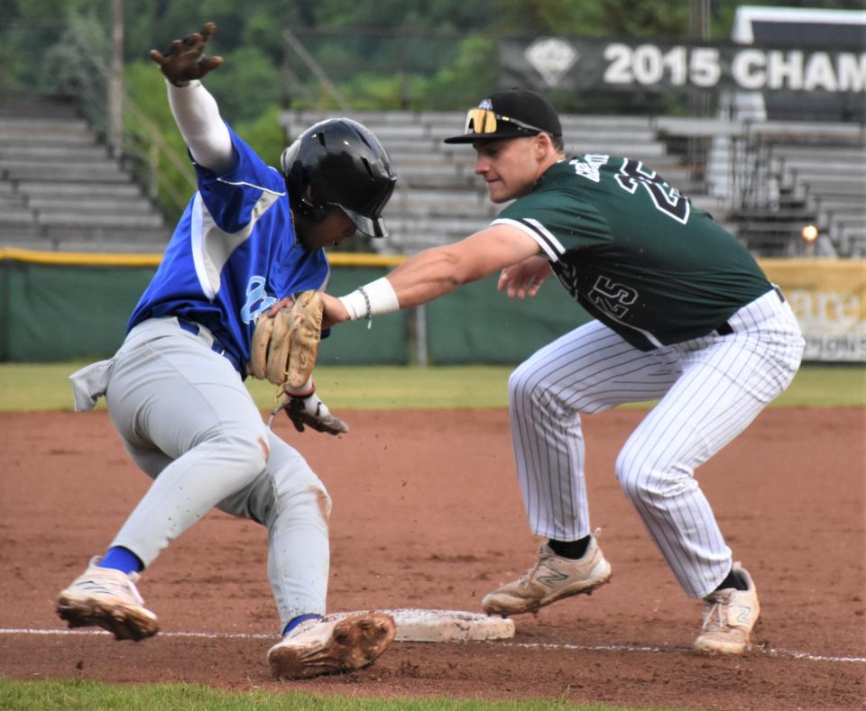 Mohawk Valley DiamondDawgs shortstop Justin Hackett (right) tags out Pablo Santos of the Utica Blue Sox after Santos overran third base during a June 8 PGCBL game at Veterans Memorial Park in Little Falls.