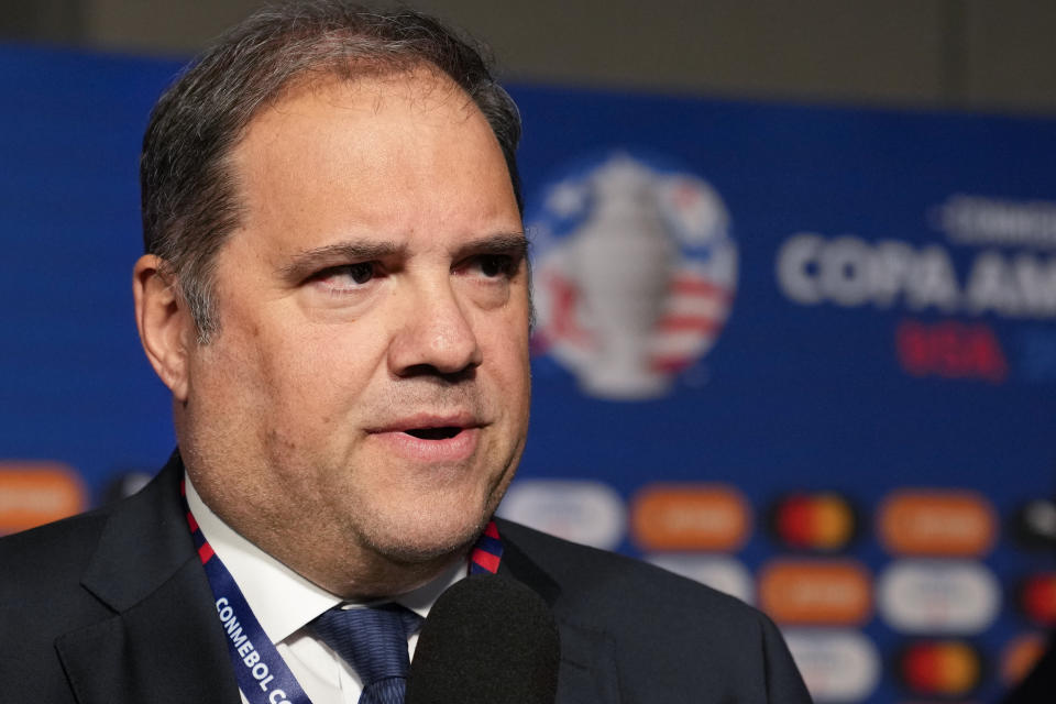 CONCACAF President Victor Montagliani talks to journalists prior to the draw ceremony for the Copa America soccer tournament, Thursday, Dec. 7, 2023, in Miami. The 16-nation tournament will be played in 14 U.S. cities starting with Argentina's opener in Atlanta on June 20, 2024. (AP Photo/Lynne Sladky)