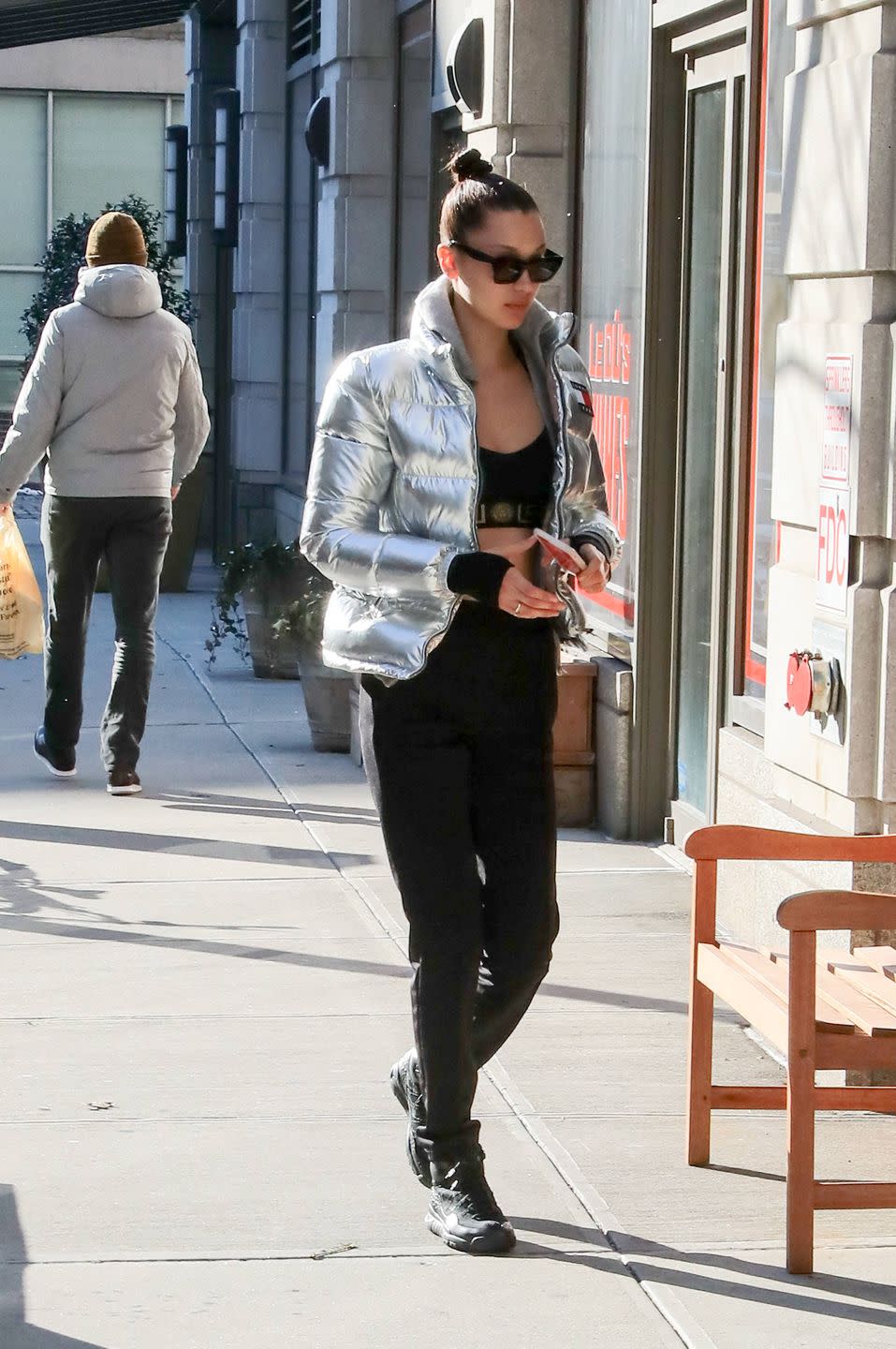 <p>Out in NYC in black pants and a black crop top and a silver Tommy Hilfiger puffer coat. </p>