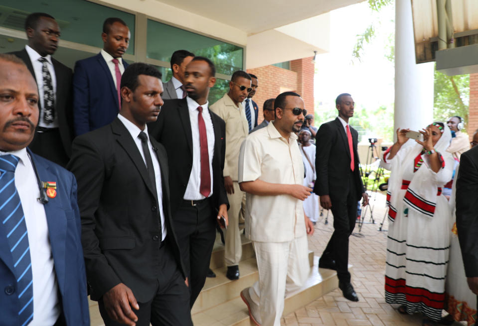 Ethiopia's prime minister Abiy Ahmed, center, arrives in Khartoum, Sudan on Friday, June 7, 2019, to try and mediate between the ruling military and the country's protest leaders amid an army crackdown that has killed over 100 people this week. Ahmed first met with Sudanese generals who in April ousted longtime autocrat Omar al-Bashir and took over the country after four months of mass protests against his rule. The protesters, however, remained in the streets, demanding the military hand over power to civilians. (AP Photo)