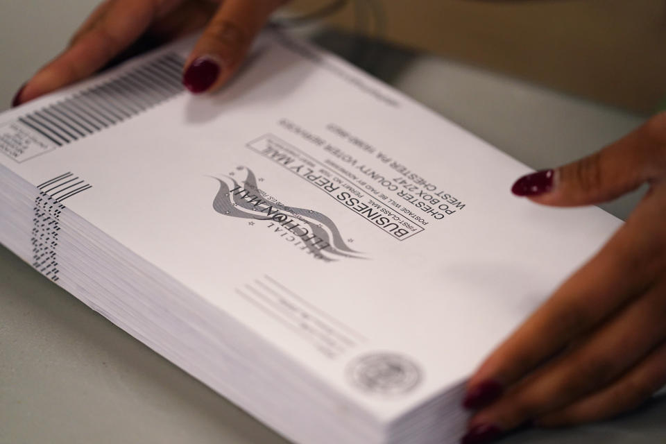 A Chester County election worker processes ballots for the Pennsylvania primary election at the Chester County Voter Services office, Thursday, May 19, 2022, in West Chester, Pa. (AP Photo/Matt Slocum)