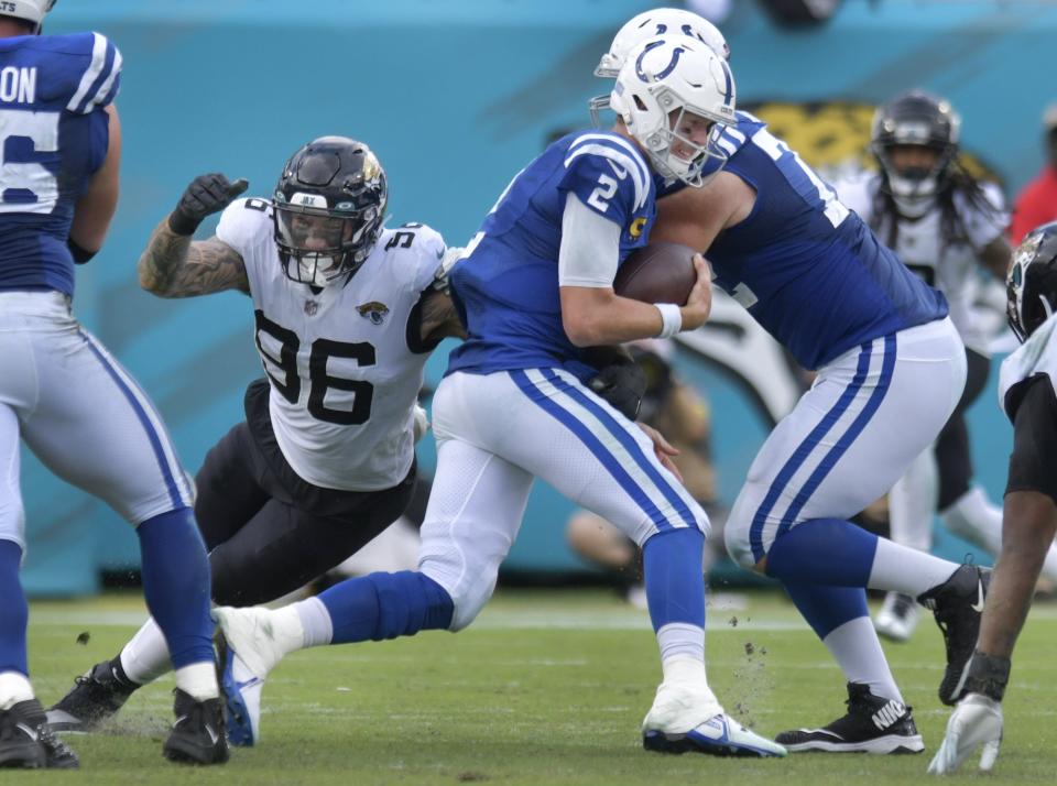 Jacksonville Jaguars defensive end Adam Gotsis (96) grabs Indianapolis Colts quarterback Matt Ryan (2) and makes a sack during fourth quarter action. The Jaguars went into the first half with a 17 to 0 lead over the Colts and went on to win the game 24 to 0. The Jacksonville Jaguars hosted the Indianapolis Colts at TIAA Bank field in Jacksonville, FL Sunday, September 18, 2022. [Bob Self/Florida Times-Union]