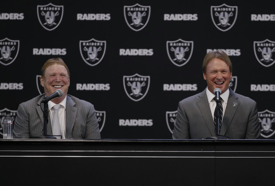 Oakland Raiders new head coach Jon Gruden, right, smiles as he sits next to owner Mark Davis. (AP)