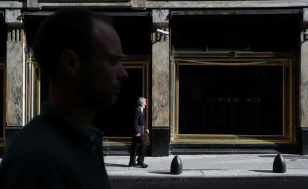 People walk past a clothing store in Buenos Aires' financial district, Argentina October 18, 2018. Picture taken October 18, 2018. REUTERS/Marcos Brindicci