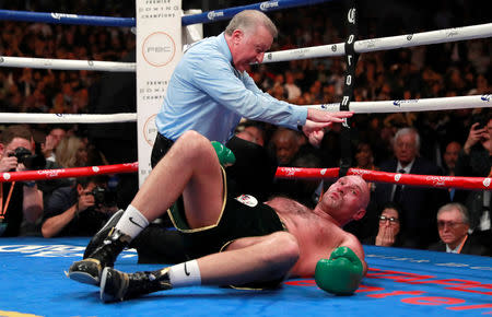 Boxing - Deontay Wilder v Tyson Fury - WBC World Heavyweight Title - Staples Centre, Los Angeles, United States - December 1, 2018 Tyson Fury with the referee after being knocked down during his fight against Deontay Wilder Action Images via Reuters/Andrew Couldridge