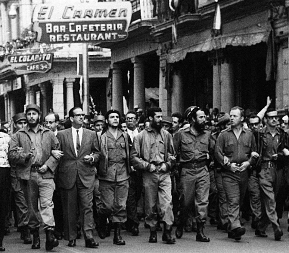 Cuban leaders walk arm-in-arm at the head of the March 5, 1960 funeral procession for the victims of the La Coubre explosion, blamed by the Cuban government on a U.S. bomb attack on the Cuban ship La Coubre in the harbor of Havana. From left to right are Fidel Castro; the first president of post-Batista Cuba, Osvaldo Dortico; Ernesto “Che” Guevara; Defense Minister Augusto Martinez-Sanchez; ecology minister Antonio Nunez-Jimenez; American William Morgan from Toledo, Ohio; and Spaniard Eloy Guttierez Menoyo. Morgan became a Cuban sympathizer after a friend was reportedly killed by President Batista’s police. He was later executed in 1961, accused of being anti-Communist.