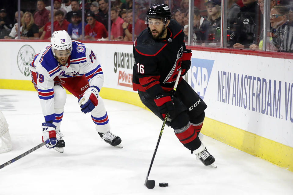 Carolina Hurricanes' Vincent Trocheck (16) controls the puck in front of New York Rangers' K'Andre Miller (79) during the second period of Game 1 of an NHL hockey Stanley Cup second-round playoff series in Raleigh, N.C., Wednesday, May 18, 2022. (AP Photo/Karl B DeBlaker)