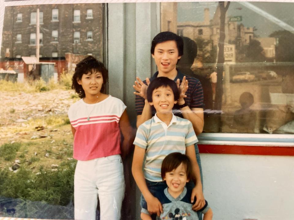 In a family photo, Curtis Chin is pictured with his cousin, Waimon, and brothers Calvin and Clifford.