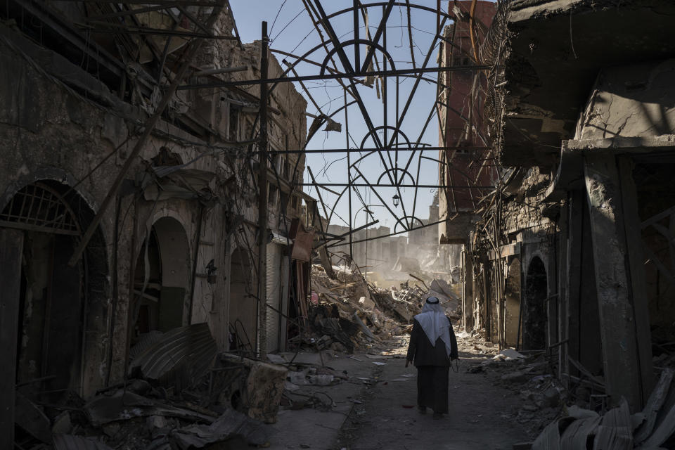 A man walks between destroyed shops in the Old City of Mosul, Iraq. (Photo: Felipe Dana/AP)