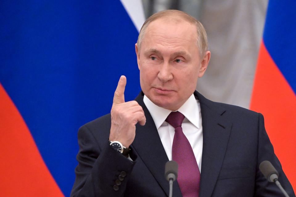 Russian President Vladimir Putin gestures as he speaks during a joint news conference with German Chancellor Olaf Scholz following their talks in the Kremlin in Moscow, Russia, Tuesday, Feb. 15, 2022.