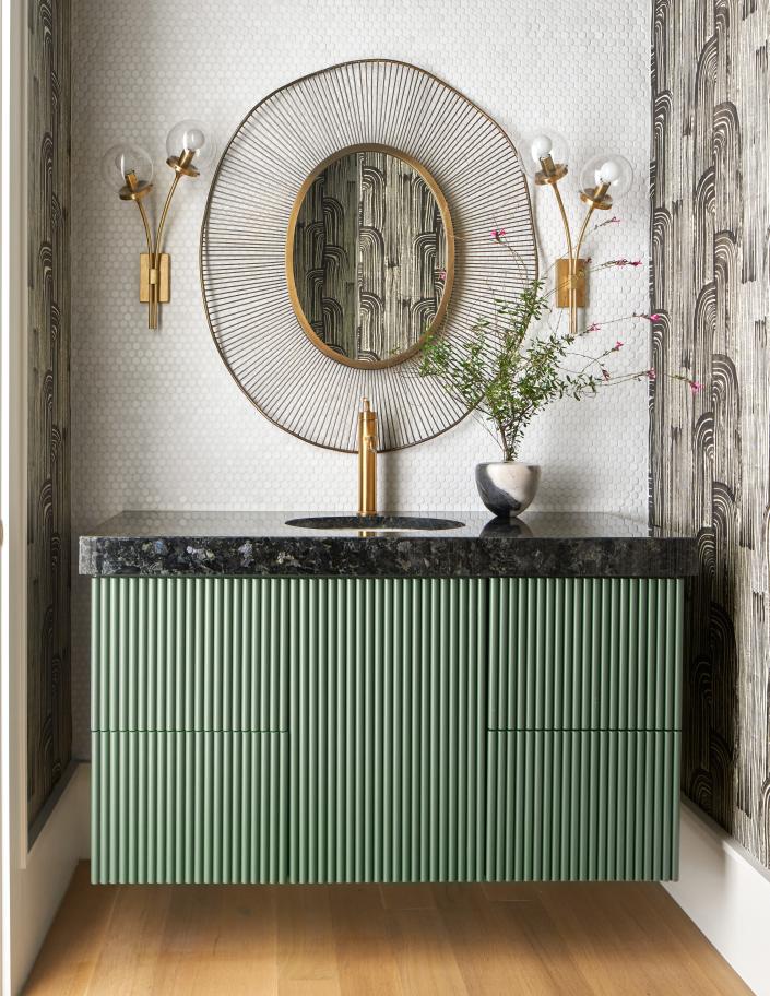 A jade reeded bathroom cabinet, installed by Maestri Studio, bring in a modern twist on texture.
