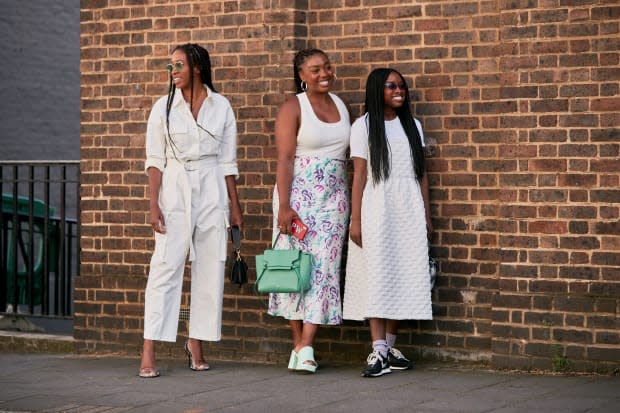 Lindsey Peoples Wagner (center) wearing a Rixo skirt during London Fashion Week in September 2019.