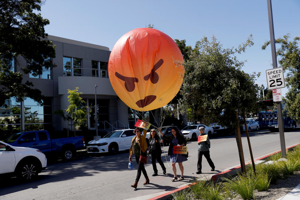 Demonstrators carry an inflatable angry emoji during a protest outside the Facebook 2019 Annual Shareholder Meeting in Menlo Park, California, U.S., May 30, 2019. REUTERS/Stephen Lam