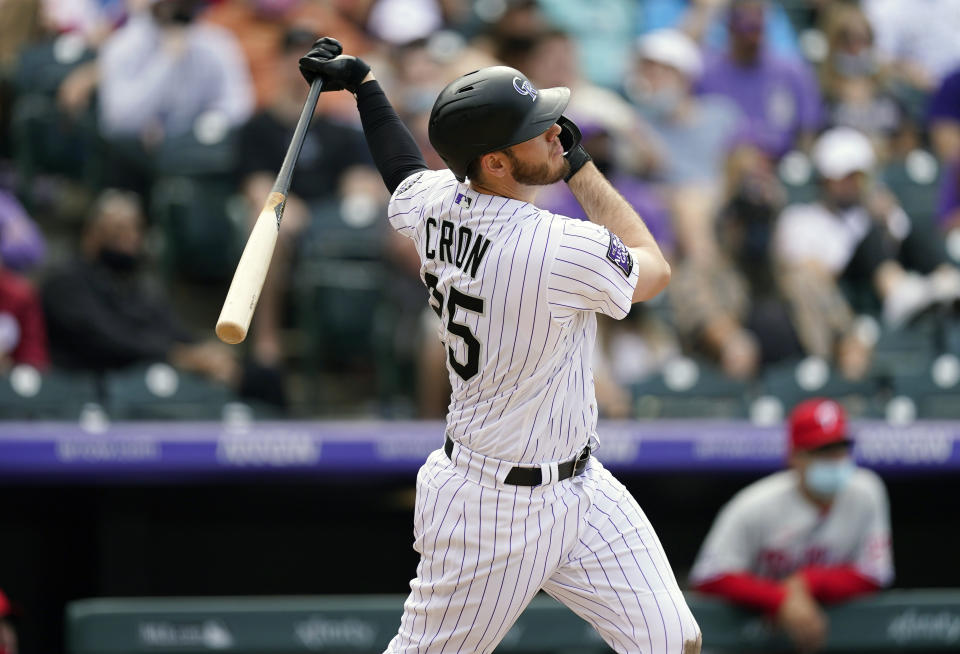 Colorado Rockies' C.J. Cron follows the flight of his two-run home run off Philadelphia Phillies relief pitcher Bailey Falter in the eighth inning of a baseball game Sunday, April 25, 2021, in Denver. Colorado won 12-2. (AP Photo/David Zalubowski)