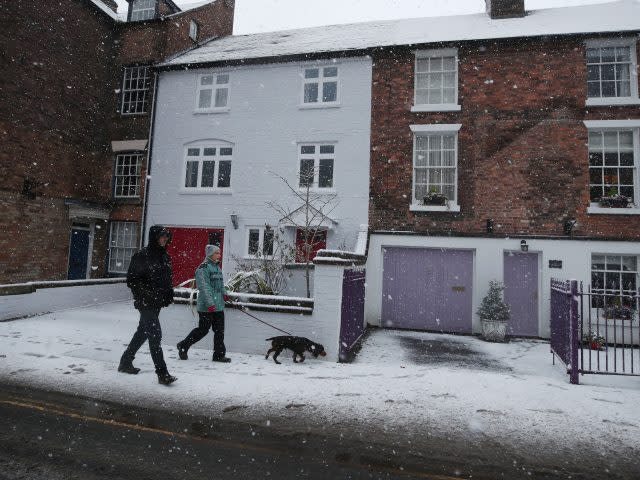 Dog walkers brave the elements in Ironbridge (Nick Potts/PA)