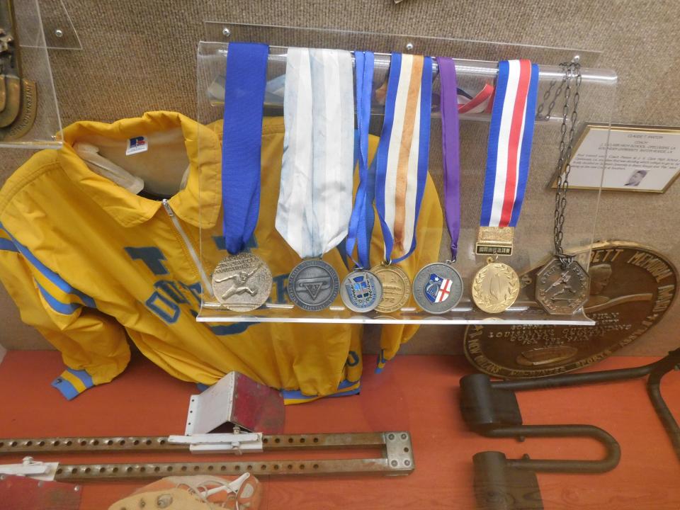 A glass showcase in the main hallway of the Opelousas Museum and Interpretive Center features the medals, memorabilia and awards that Opelousas native Rodney Milburn won during his track career at Southern University. In 1972 Milburn won a Summer Olympics gold medal in the hurdle events.