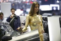 A model poses for the unveiling of the Bertone Jet 2+2 at the 2013 Geneva Motor Show.